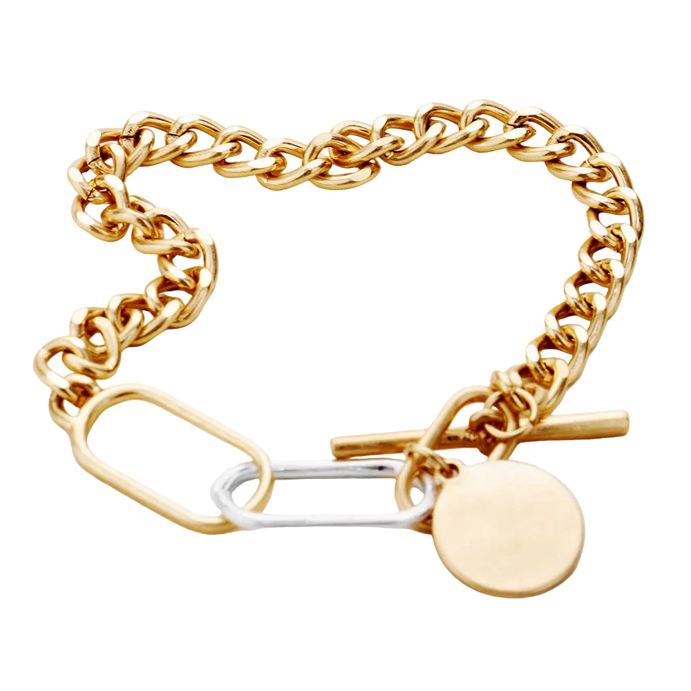 A two-tone gold chunky metal chain bracelet with a disc charm and toggle closure.
