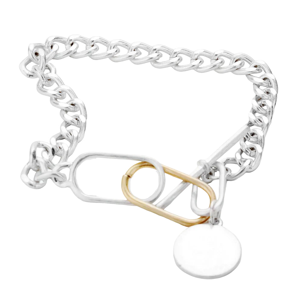 A two-tone chunky metal chain bracelet with a disc charm and a toggle closure.