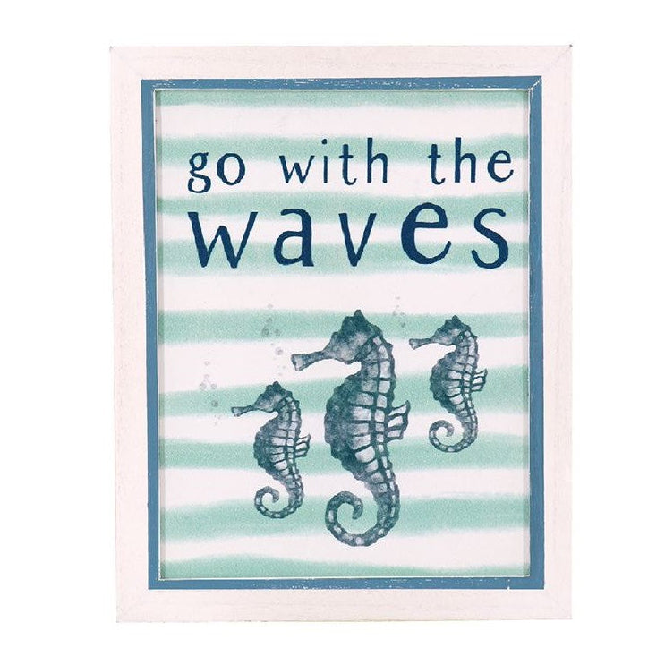 A natural wood sign featuring seahorses and the text 'Go With The Waves' on a striped background.