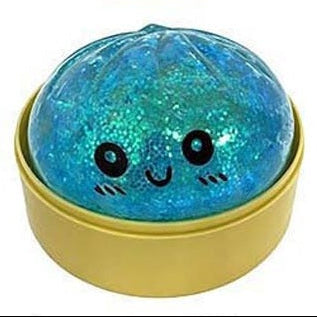 Blue glittery ball with a smiling face in a yellow container on a white background