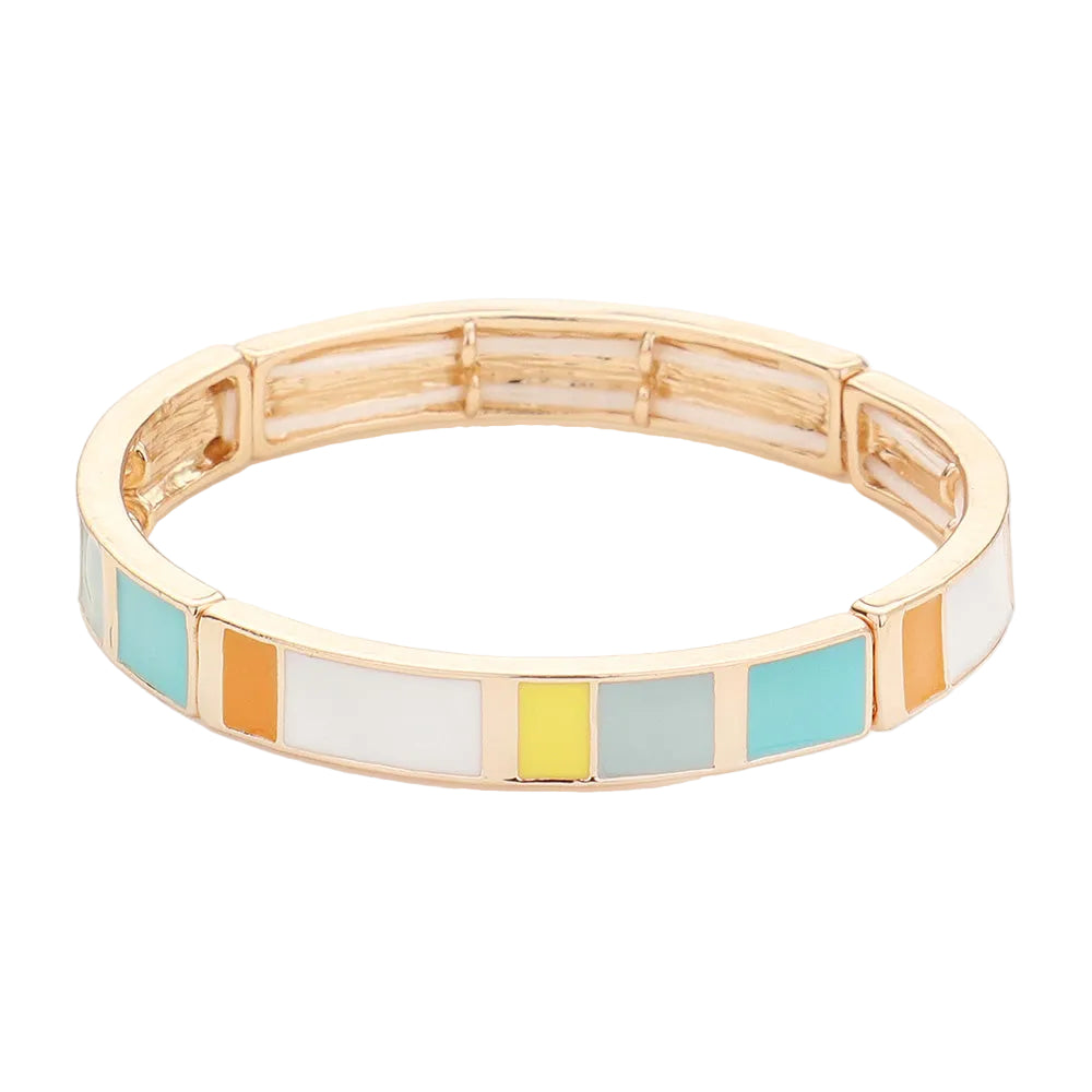 A stretchable gold tone bracelet with color blocks in white, mint green, and yellow.