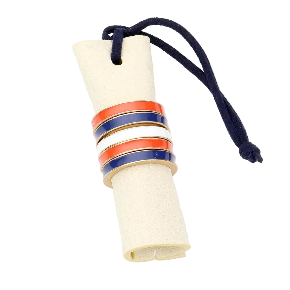 A set of five color block stackable rings with red, blue, white, and multicolor enamel on a worn gold band, attached to a navy blue string.