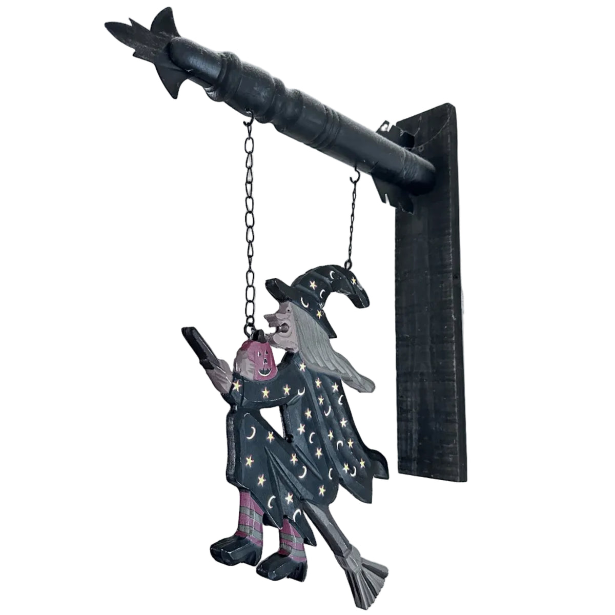 Whimsical flying witch on broomstick hanging arrow sign with stars, moons and jack-o’-lantern. A charming vintage-inspired Halloween decoration.