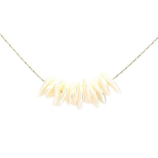 A delicate gold chain necklace featuring a curved row of small, irregular cream-colored shell beads, presented on a solid white background.