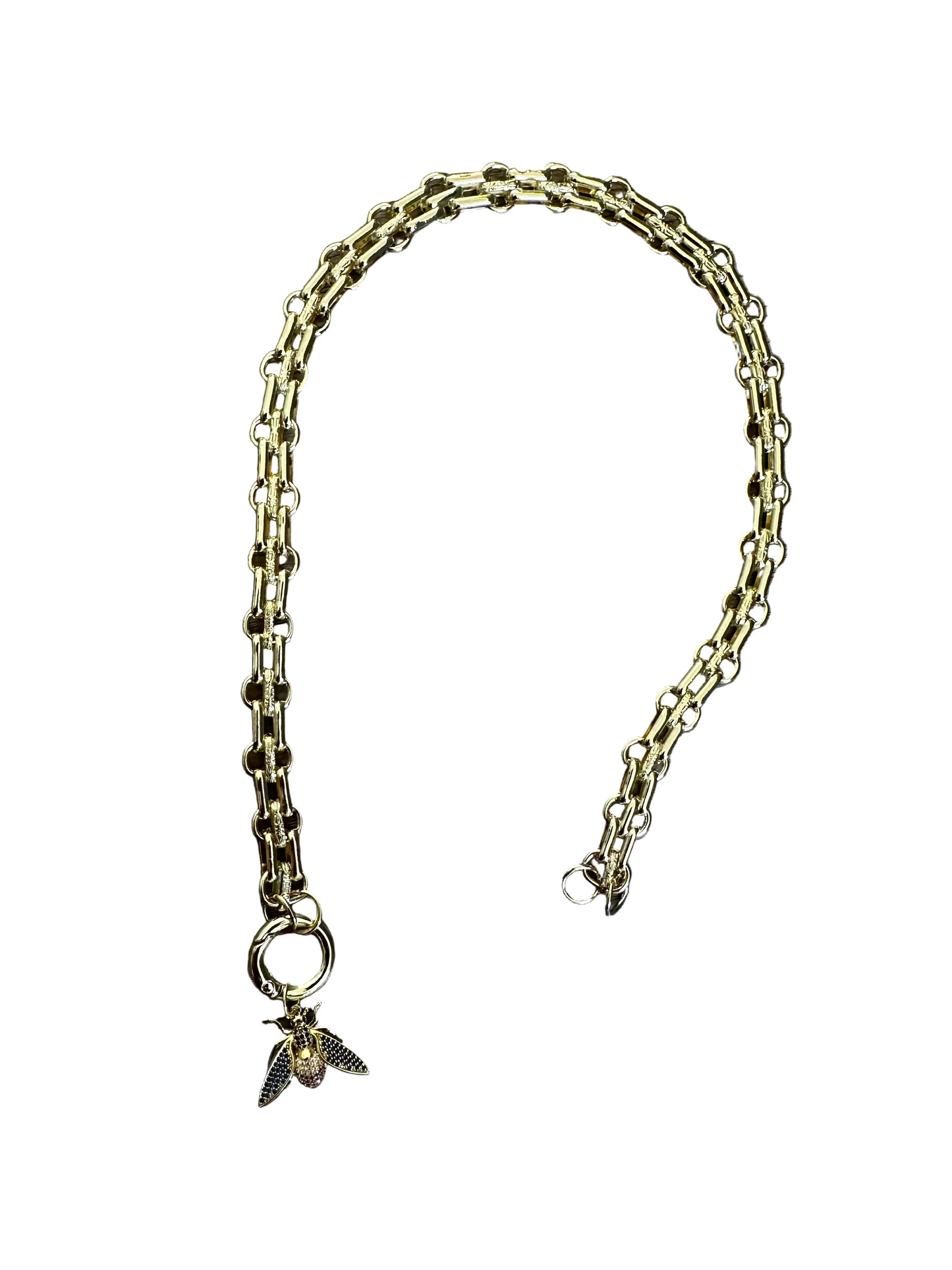 Gold chain necklace with a bee charm on a white background
