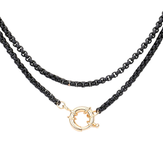 A double-strand black chain necklace with a gold-tone circular toggle clasp, displayed against a solid white background.