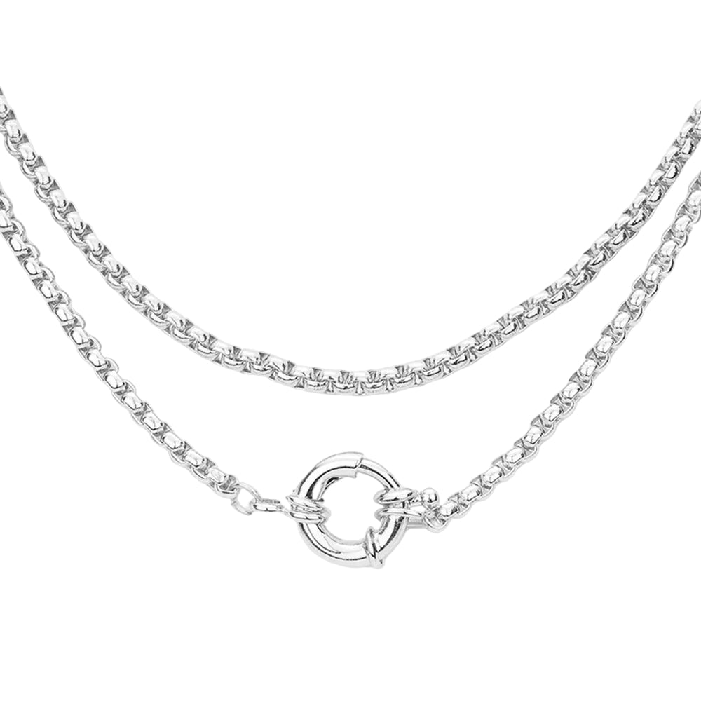 A double-layered silver chain necklace featuring a classic curb chain on the top layer and a thinner box chain on the bottom layer, finished with a polished circular ring clasp, shown against a plain white background.