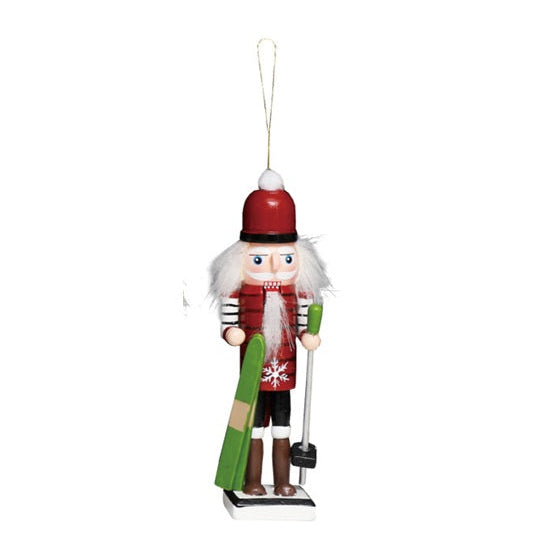 Wood skier nutcracker Christmas ornament holding green skis and a ski pole.