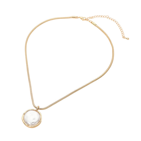 Gold necklace with a white pendant on a white background