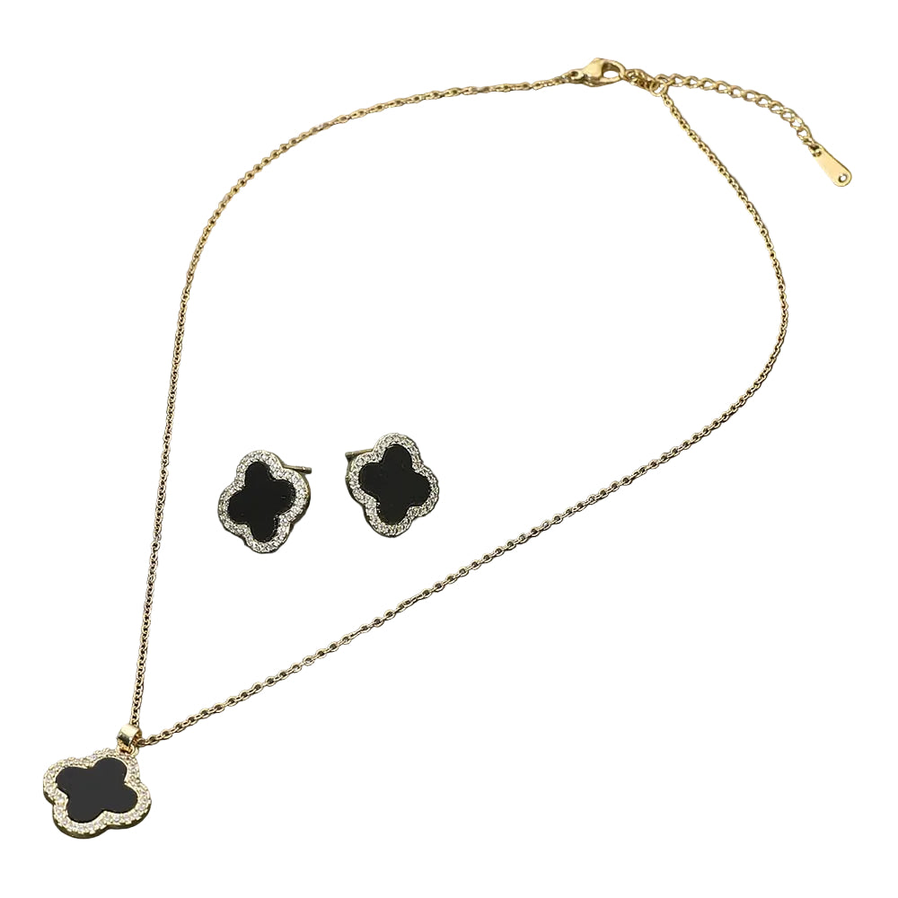 Gold necklace and earrings with black clover-shaped pendants on a white background