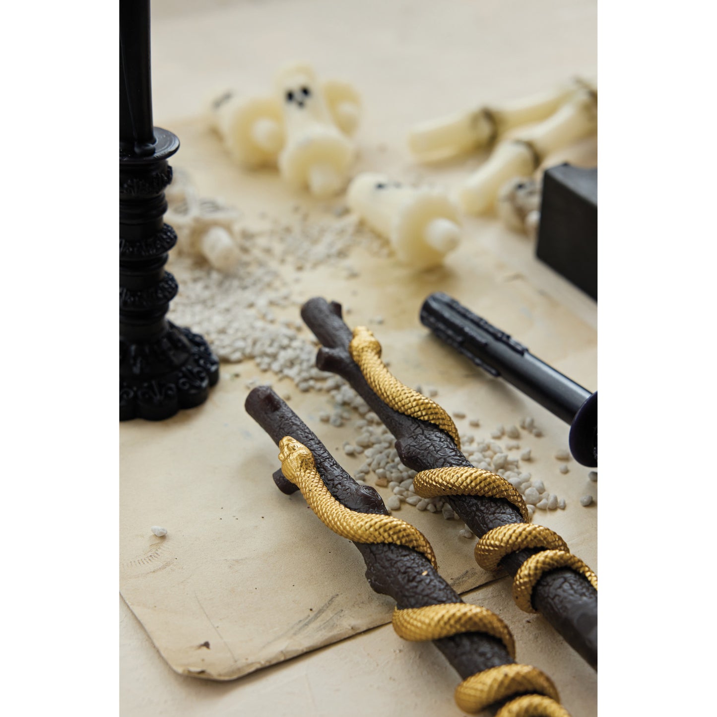 Close-up of black and gold rope handles on a white background