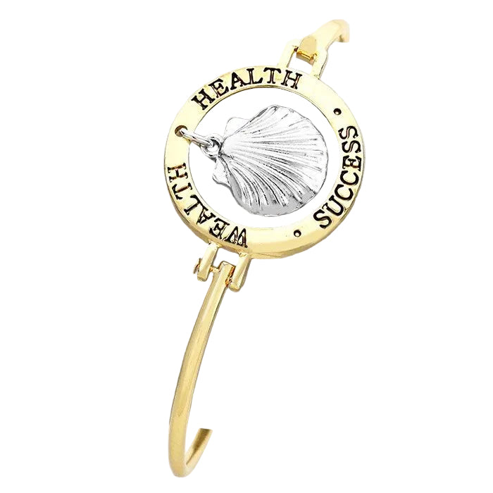 Antique gold bracelet with a message and sea life theme, featuring a scallop shell design.