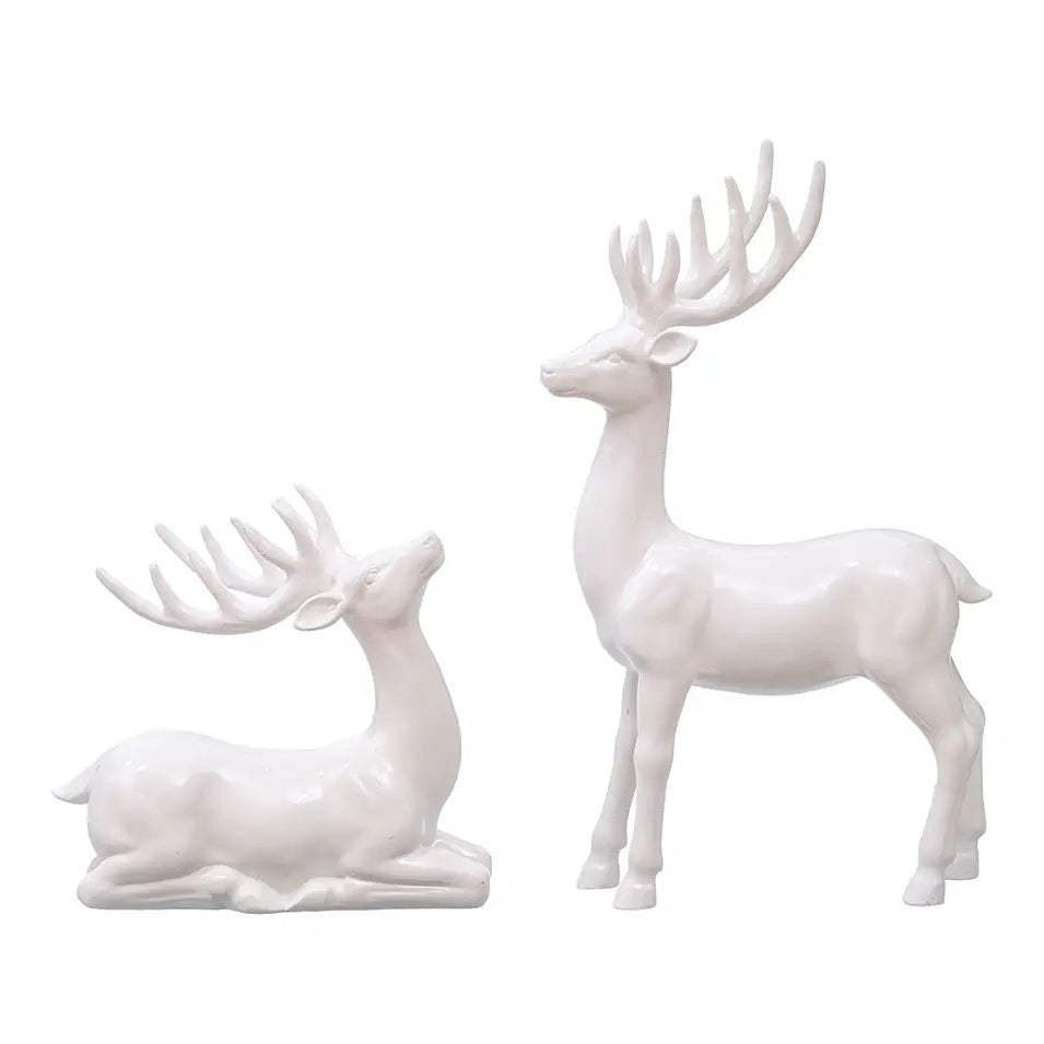 Add elegance to your holiday décor with a set of 2 glossy white reindeer figurines. Perfect for Christmas mantels, centerpieces and winter displays.