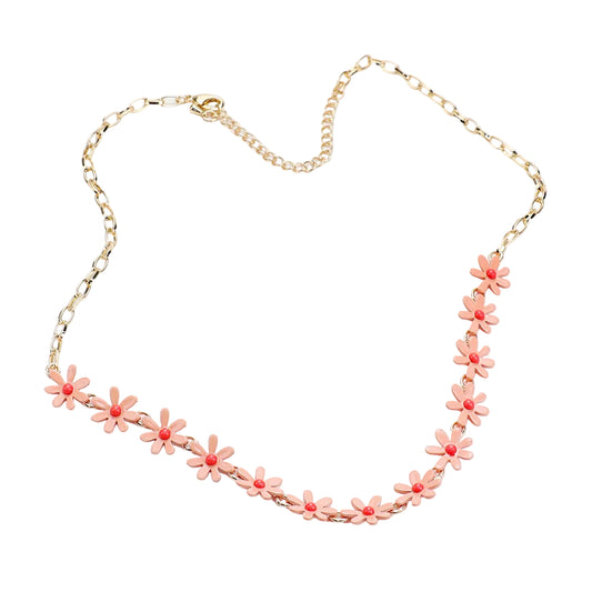 A gold chain necklace featuring a row of small pink daisy flowers with gold centers, displayed on a clean white background.