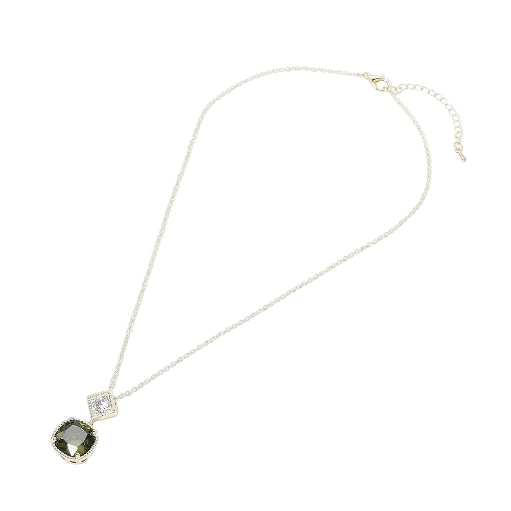 Necklace with a pendant featuring a green gemstone and clear crystal on a white background
