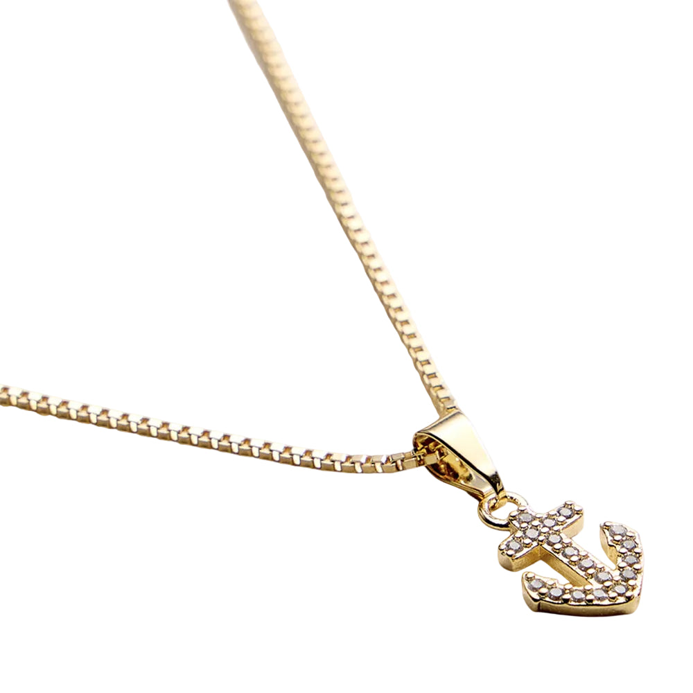 Gold anchor pendant necklace on a white background