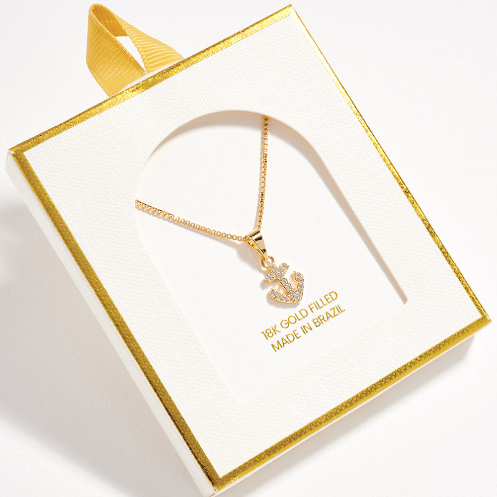 Gold necklace with anchor pendant in a decorative box