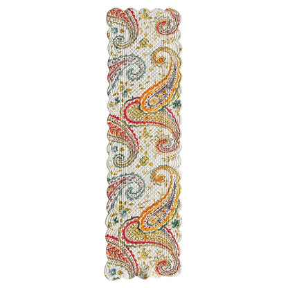 A rectangular woven table runner with a dense paisley pattern in red, orange, yellow, green, and blue on a cream background, shown flat against a white background.