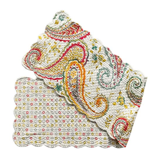 Decorative table runner with scalloped edges. One side features a small multicolor floral pattern on a cream background, and the other features a larger paisley pattern in orange, red, green, and blue on a cream background.