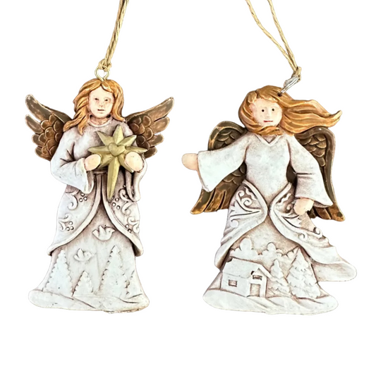 Two angel Christmas ornaments with long brown hair, white dresses, and brown wings, hanging on a white background.