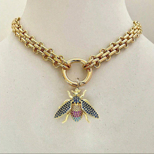 Gold chain necklace with a colorful bee pendant on a mannequin.