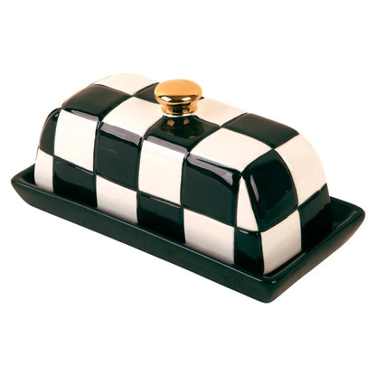 Black and white checkered ceramic butter dish with a solid black base and gold-tone knob. A playful, polished addition to the kitchen or table.