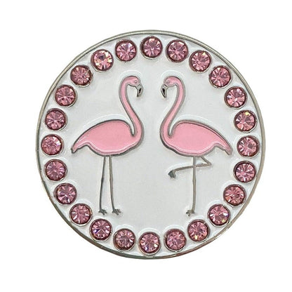Circular magnetic golf ball marker with pink flamingo design and gemstones on a white background