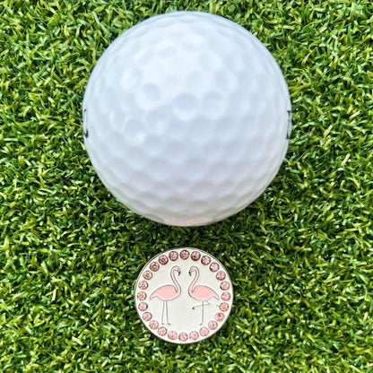 Golf ball on grass with a flamingo-themed marker
