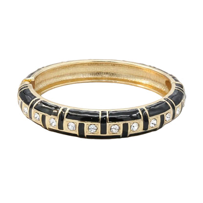 Gold and black bracelet with diamond accents on a white background