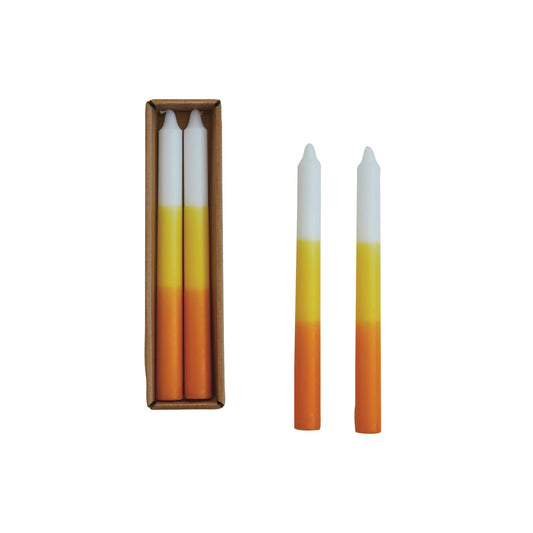 Gradient candles with orange to white color transition, one in a box, on a white background
