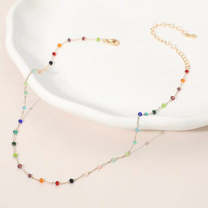 Necklace with multicolored beads on a white dish