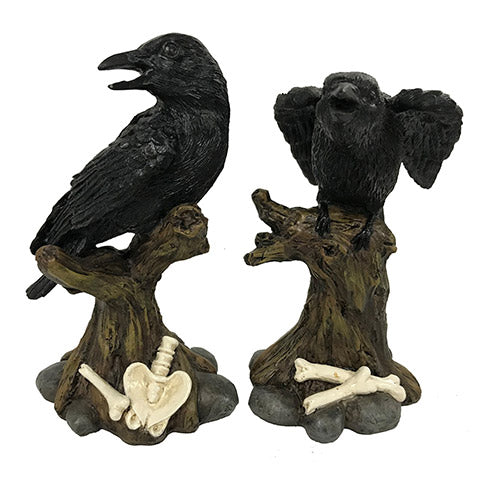 A set of two Halloween decorations featuring a crow perched on a branch with bones scattered around the base. The crow is black with a realistic appearance, and the branch is brown with a natural texture.