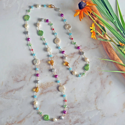 Long rosary-style necklace featuring cultured pearls and colorful crystals.