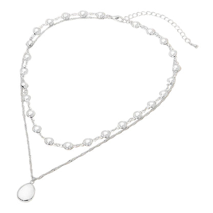 Double-layered pearl necklace with a pendant on a white background