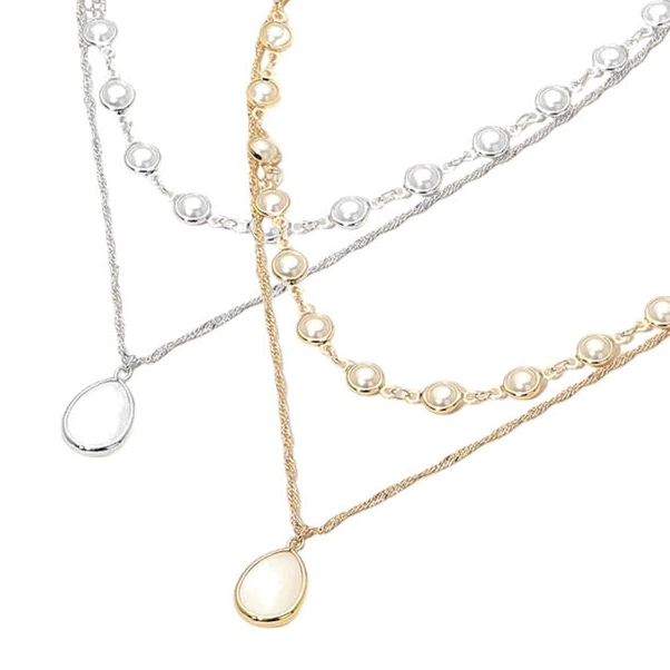 Two pearl necklaces in gold, silver, and ivory on a white background