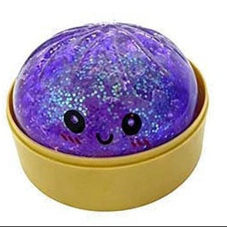 Purple glittery ball with a smiling face in a yellow container on a white background