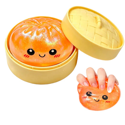 Cute orange squishy dumpling in a yellow container with a hand holding one of the toys.