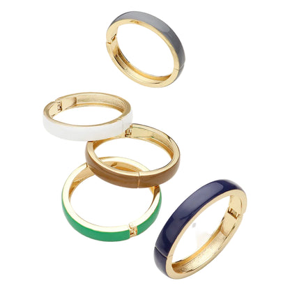 Set of gold rings with colorful bands on a white background
