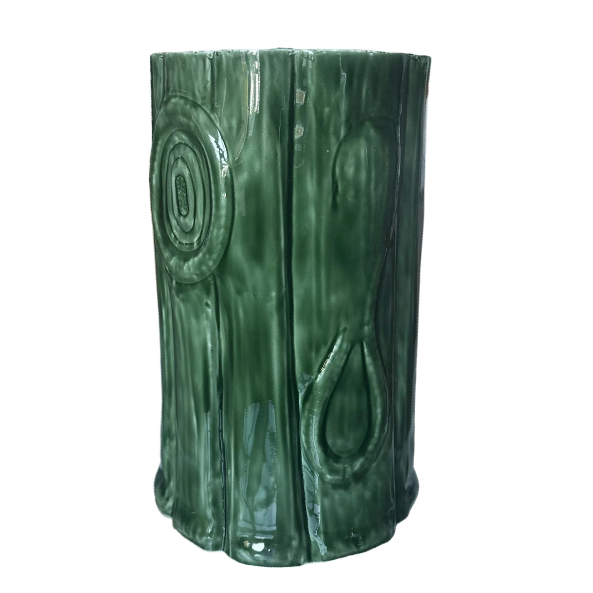 A green metal enameled tree trunk stool with a textured, ribbed design resembling stacked wood or leaves, displayed on a white background.