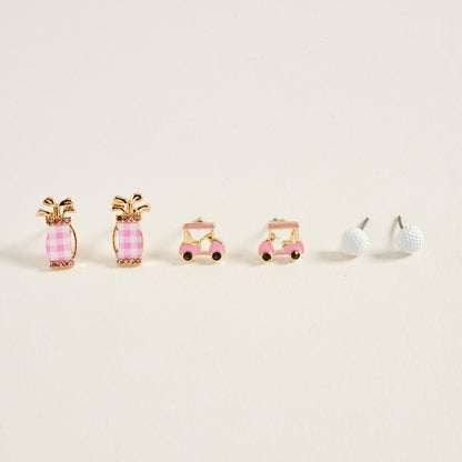 Set of three earrings shaped like a golf bag, cart, and ball on a beige background