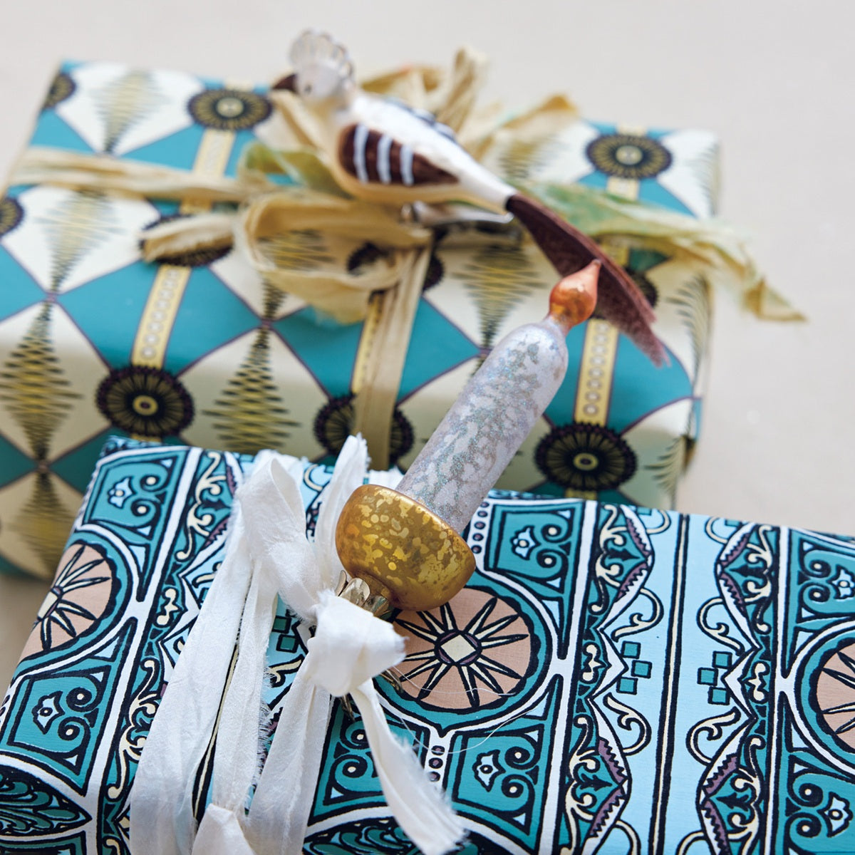 Decorative gift wrap with geometric patterns and gold accents on a white background
