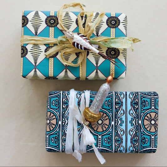 Two wrapped gifts with decorative ribbons on a light background