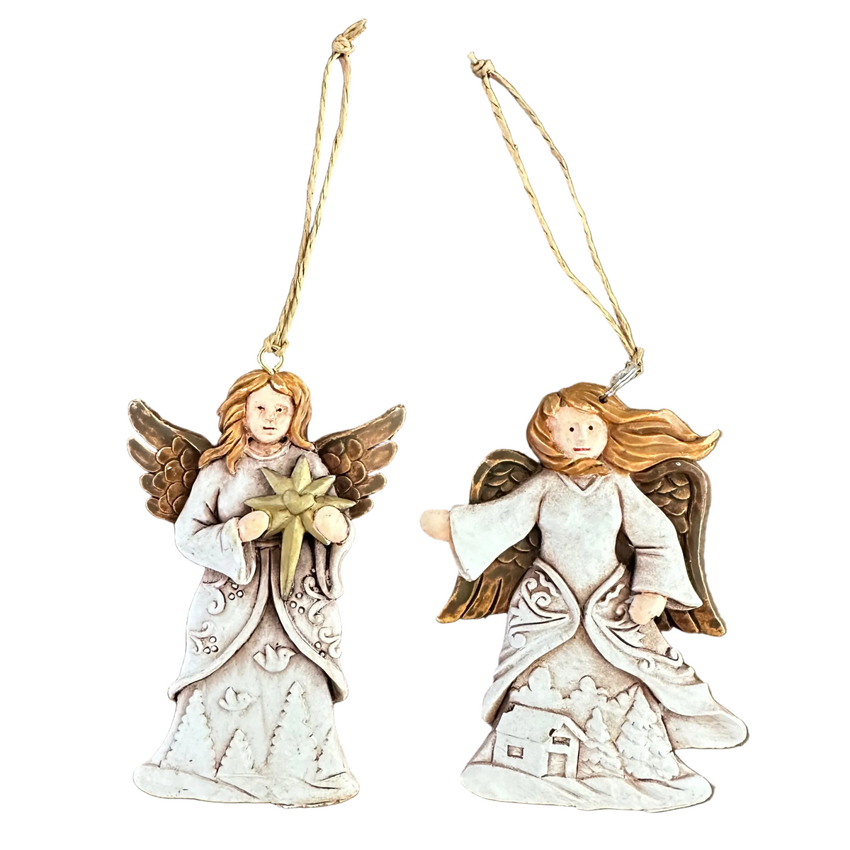 Two angel Christmas ornaments on a plain white background. One angel holds a gold star, and the other depicts a small house with trees on the dress.