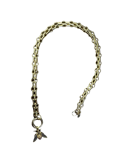Gold chain necklace with a bee charm on a white background