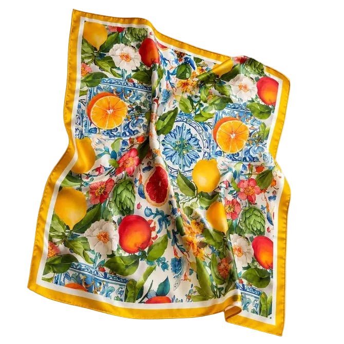 A square silk scarf with a vibrant citrus and floral print, featuring a bright yellow border, laid flat on a white background.