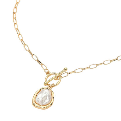 Gold necklace with a teardrop-shaped pearl pendant on a white background