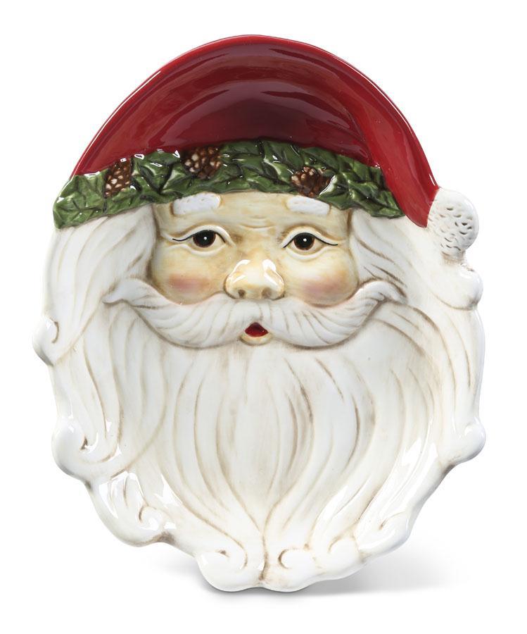 A ceramic Santa Claus face dish or bowl with a glossy red hat, green holly trim, and a detailed white beard, shown on a plain white background.