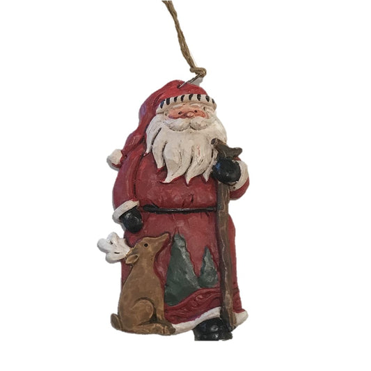 A carved wooden Christmas tree ornament featuring Santa Claus with a deer, holding a staff, and wearing a red outfit.