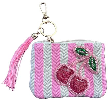 Pink and white striped cherry coin purse featuring sparkling beaded cherries, a pink tassel, and gold-tone keychain clip.