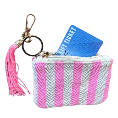 Pink and white striped coin purse featuring a pink tassel, zipper closure, and gold-tone keychain clip.